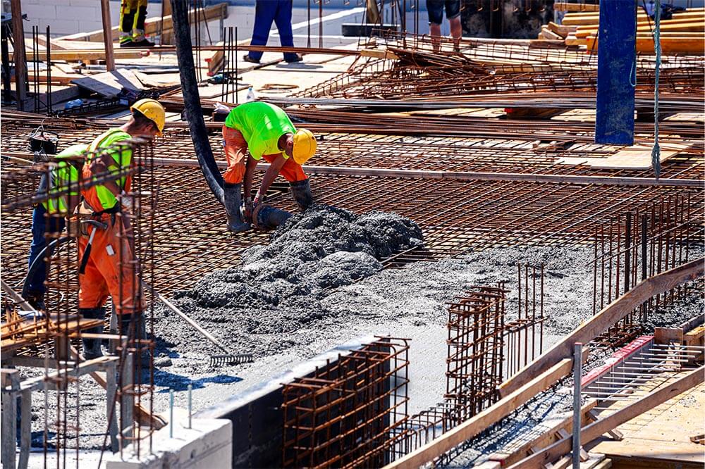 PSW Concrete constructor worker pouring concrete on a job site