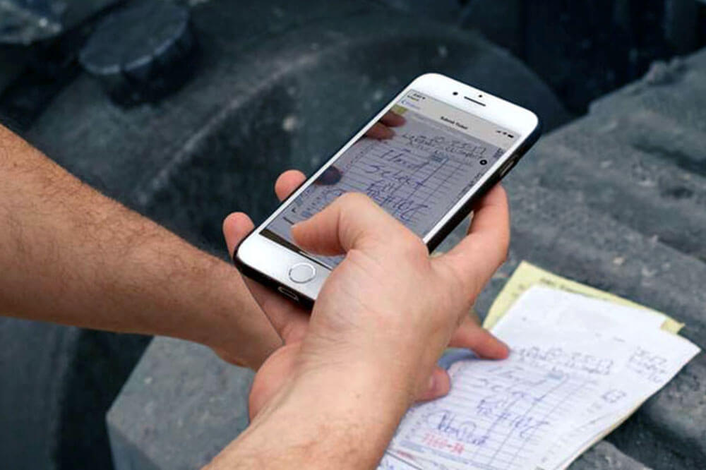 scaning a ticket hand using a mobile phone to scale a paper ticket
