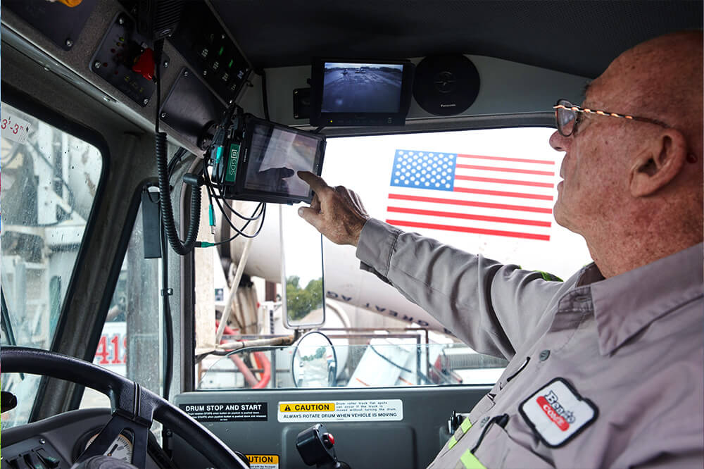 trackit2 man in truck cab touching a touch screen tablet